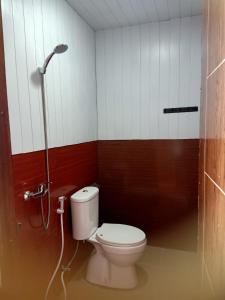 a bathroom with a toilet and a shower stall at Istana Bromo Resort in Bromo
