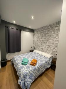 a bedroom with a bed with two towels on it at APARTAMENTO TROMPETA GaRaJe in Logroño