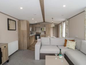 a living room with a couch and a table at Lodge 9 in Winscombe