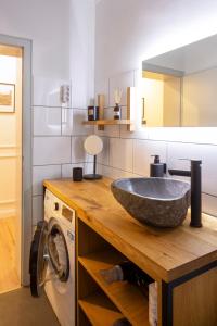 La salle de bains est pourvue d'un lavabo en pierre sur un comptoir. dans l'établissement Renoviertes Design Apartment mit Toller Terasse, à Mülheim