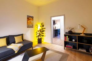 a living room with a couch and a table at Renoviertes Design Apartment mit Toller Terasse in Mülheim an der Ruhr +12 photos