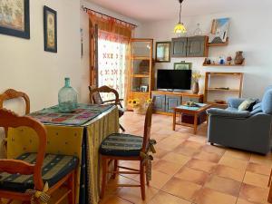 a living room with a table and a tv at Apartamento Rubire in Vejer de la Frontera +15 photos