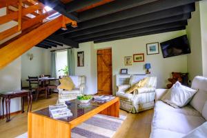 a living room with a couch and a table at Lakeside Cottage in Carmarthen