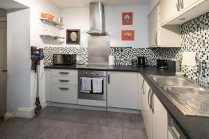 a kitchen with a sink and a stove at Westwood Guest House - Room Only in Lyme Regis