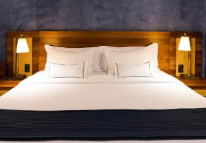 a large white bed with two pillows on it at Tivoli Ecoresort Praia do Forte in Praia do Forte