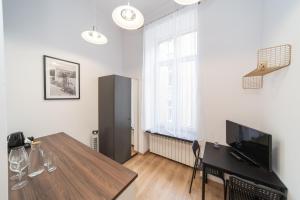 a living room with a table and a large window at VIPoL Pokoje Biznesowe in Łódź