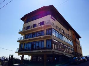 a tall building with balconies on the side of it at Apart Hotel Bonjour Cluj in Cluj-Napoca