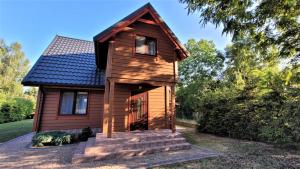 a tiny house with a porch and a roof at Dom Derbend in Sztutowo