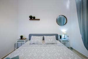 a bedroom with a large bed with two tables at Cozy apartment with seaview and parking in Adeje