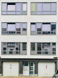 a facade of a building with multiple windows at Dé Studio, oase van rust en romantiek in de stad. in Antwerp