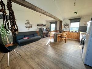 a living room with a couch and a table at Slow Travel Mývatn - Óli's Homestay-Private house v in Myvatn