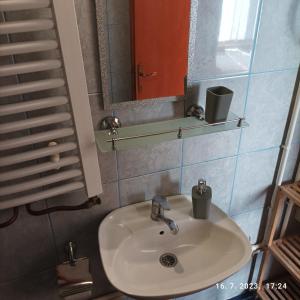 a bathroom with a sink and a mirror and a mirror at Apartments Dobra Vila in Zlatibor