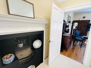 a fireplace with a mirror above it in a living room at Porters Coffee Shop and B&B in Helmsley