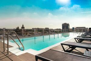 a large swimming pool on the roof of a building at Hotel Giralda Center in Seville
