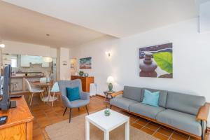 a living room with a couch and a table at BeGuest Gandarinha Apartment in Cascais