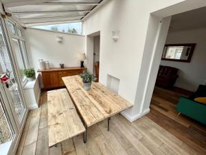 a living room with a wooden table in a house at Spacious Family home in Cardiff with Parking! in Cardiff