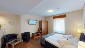 Postel nebo postele na pokoji v ubytování Hotel Ambassador