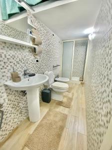 a bathroom with a sink and a toilet at Pamela House in Noto