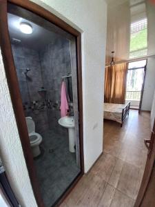 a bathroom with a shower and a toilet and a sink at Leto by Sveta in Ureki