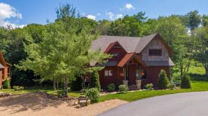 a red house with a gambrel roof at The Sheltered Elk at Eagles Nest in Elk Park