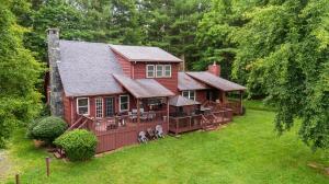 an aerial view of a red house with a deck at Serenity Now in Fleetwood