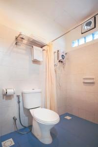 a bathroom with a toilet and a shower at Tuna Bay Island Resort in Perhentian Islands
