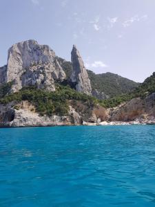 a view of a mountain from the water at Montecool in Baunei