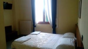 Postel nebo postele na pokoji v ubytování Hotel Greco