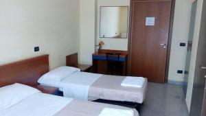 Postel nebo postele na pokoji v ubytování Hotel Greco
