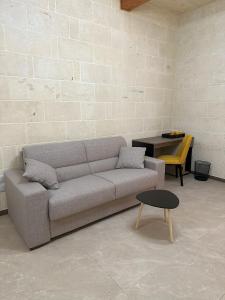 a living room with a couch and a table at Sea Holly Gozo in Nadur