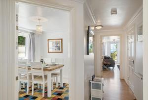 a dining room and living room with a table and chairs at Blue Horizon in Carbis Bay