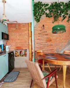a kitchen with a table and a brick wall at kushki's home in Tbilisi City