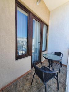 a room with a table and chairs and a window at Hotel N in Tskaltubo