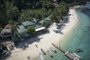 an aerial view of a beach with boats in the water at Tuna Bay Island Resort in Perhentian Islands