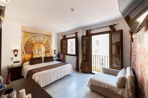 Posteľ alebo postele v izbe v ubytovaní Hotel Casa Museo de la Mezquita + 37 fotografií