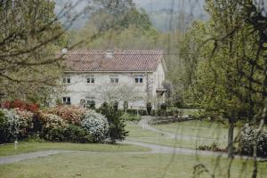 a large white house with a path in front of it at Amalurra Ecohotel & Retreat Center in Artzentales