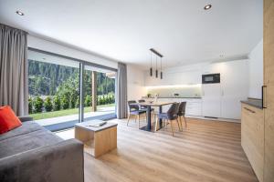 a living room with a couch and a table at Apartments Chalet Silva in Selva di Val Gardena