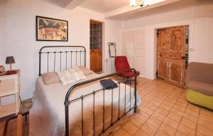 a bedroom with a bed and a desk and a chair at Gite Champêtre Drome Lorette in Marsanne