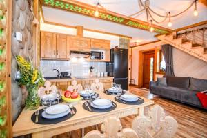 a kitchen and living room with a table with food on it at Domki u Górala in Zakopane