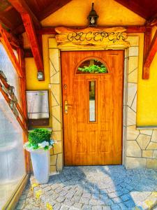 a wooden door of a house with a potted plant at Ski&Spa Zieleniec in Zieleniec