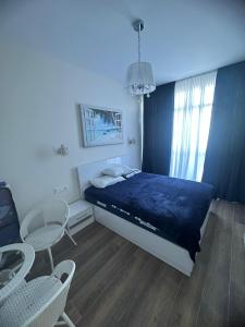 a bedroom with a bed and a table and chairs at Family Inn in Gonio