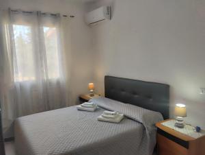 a bedroom with a bed with two towels on it at Da Maurizio e Luisa in Castiadas