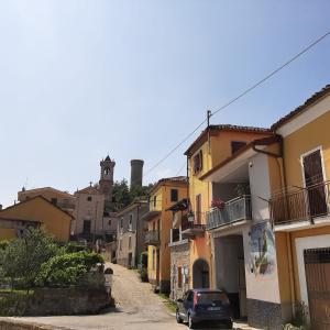 a street in a town with a car parked on the street at Peter Pan in Castellino Tanaro