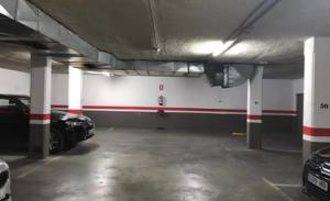 a parking garage with a car parked in it at Apartamento HARMONY en el centro de Fuengirola in Fuengirola