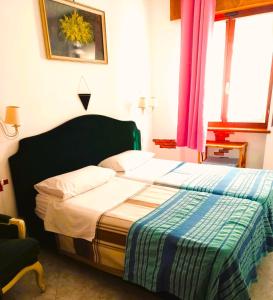 a bedroom with a bed with a striped blanket on it at Cozy!! Verona in Verona