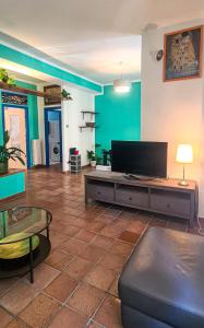 a living room with a flat screen tv and a couch at La Pinetina in Ancona