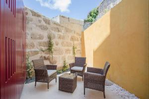 a group of chairs and a table on a patio at Downtown Cosy Suite VI in Porto