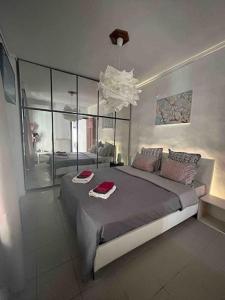 a bedroom with a large bed and a chandelier at 95sqm 7min Center 2bedroom Gas heating Marble Wc 2 SmartTv in Thessaloniki