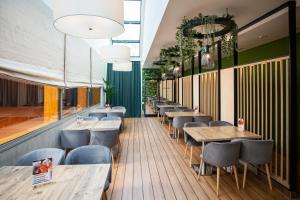 a row of tables and chairs in a restaurant at Hotel Bażantowo Sport in Katowice