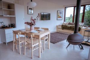 a kitchen and living room with a table and a stove at Chata nad Kocábou in Štěchovice